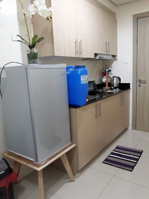 kitchen with refrigerator, oven toaster, rice cooker, and other kitchen utensils
