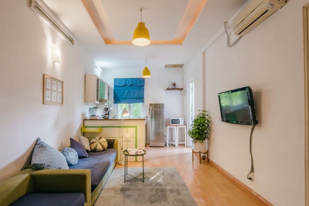Living room with aircon and full of light together with kitchen