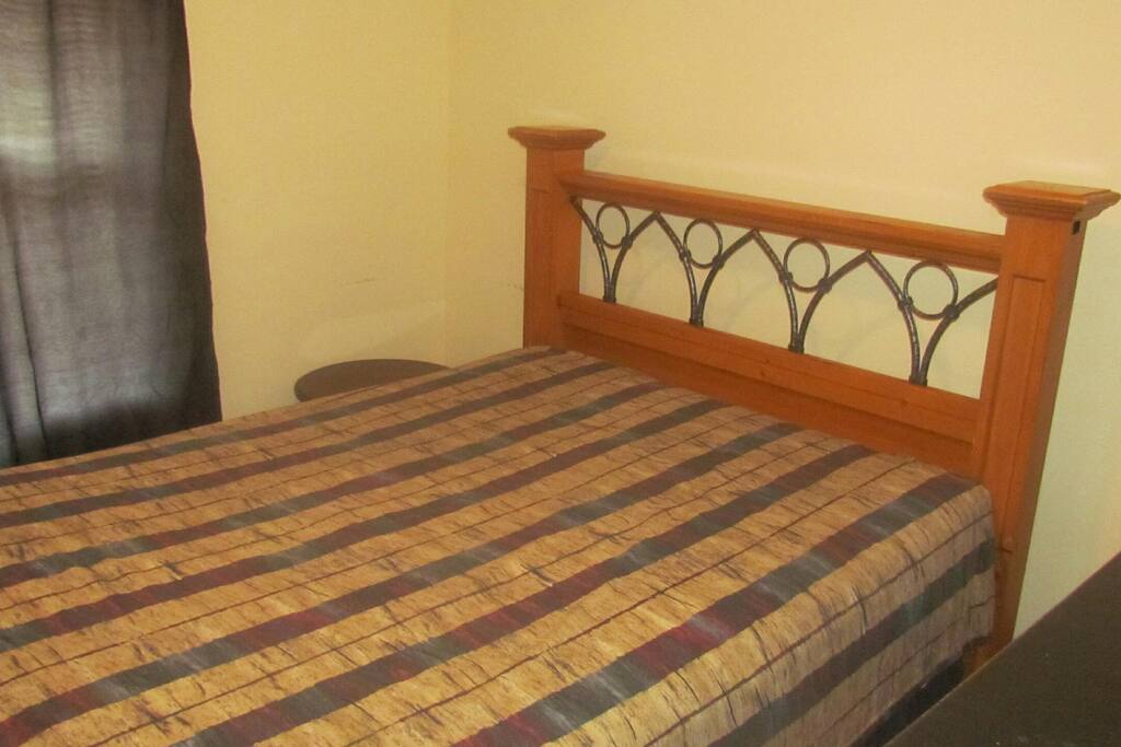 The room is sunny, located in the front of the house and has a queen size bed.