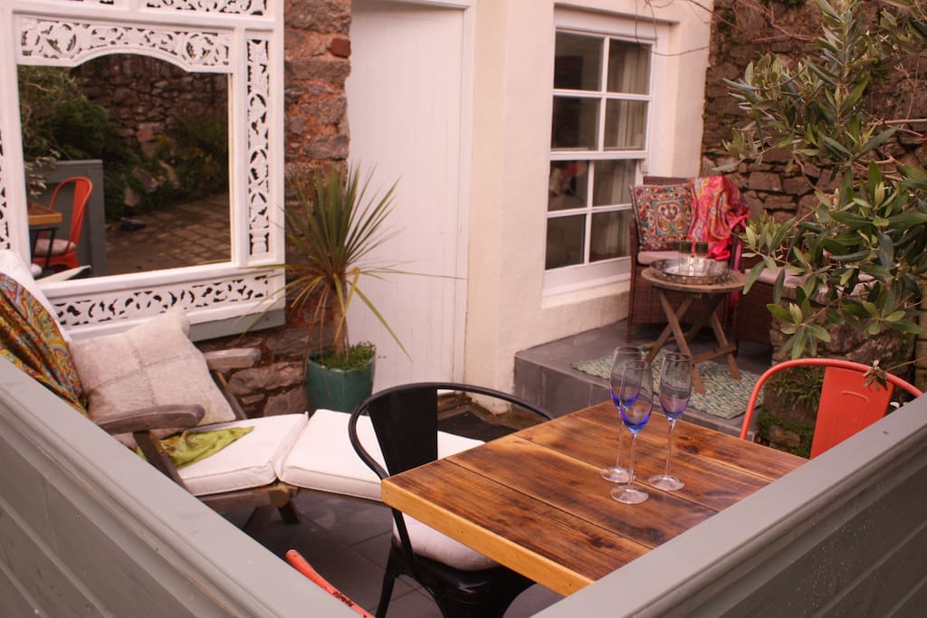 The Studio's walled terrace with sun lounger and dining area