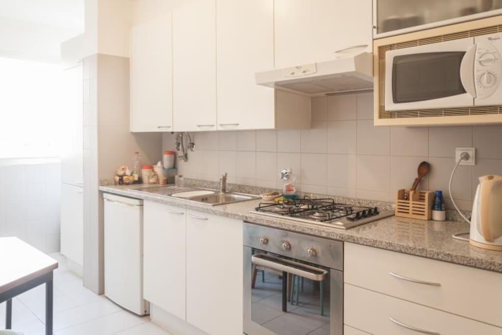 Kitchen equipped with tableware and microwave