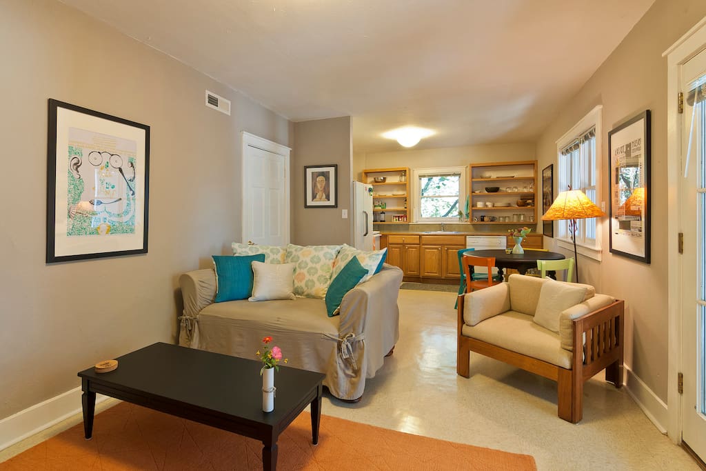 Living room and dining area with kitchen at opposite end.