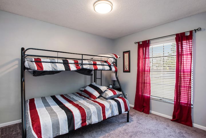 The third bedroom has a twin over full sized bunk bed and a kids' play area.