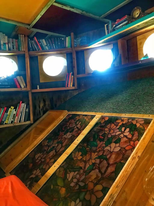 The Library has plenty of natural lighting with sky lights and has stained glass windows overlooking the FUNkey House Living room.