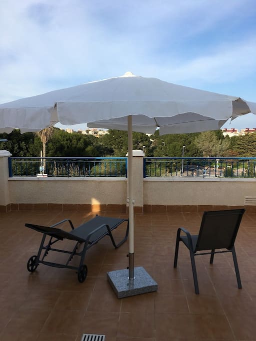 Privat roof terrace with sunbeds and chairs and table