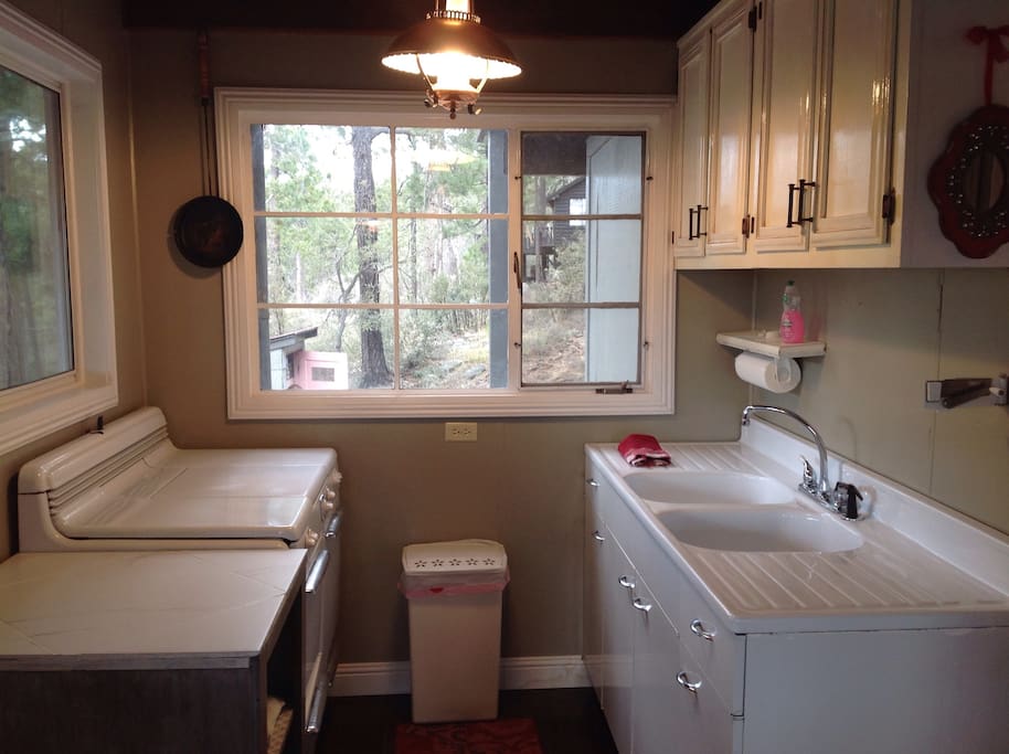 Full kitchen with antique metal propane stove.
