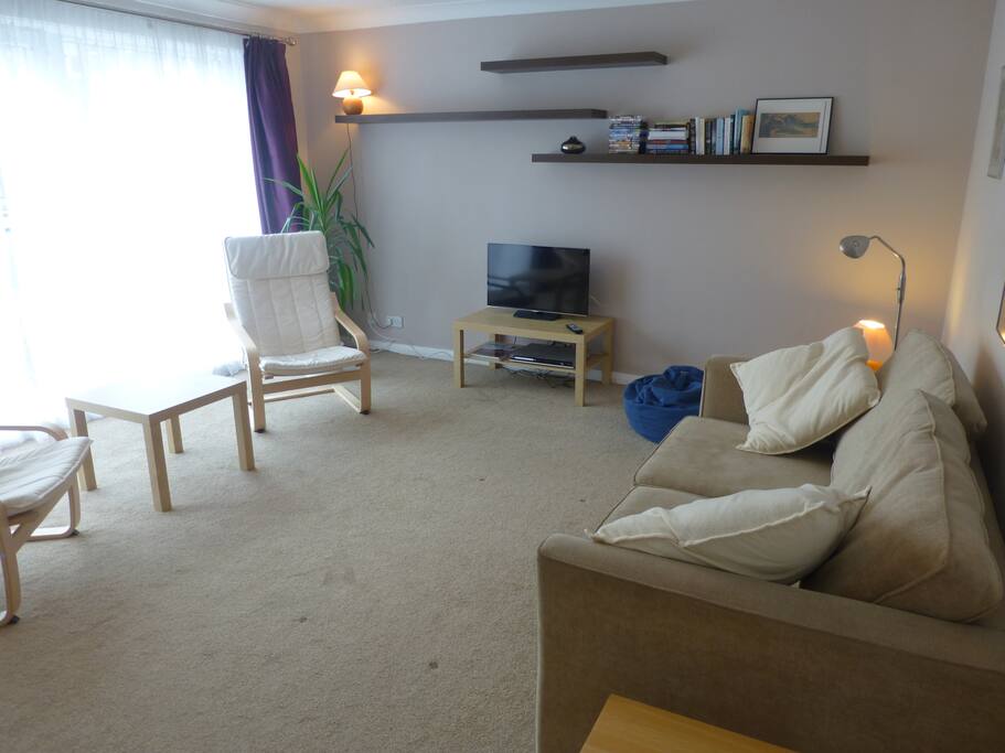 The living-room has floor-to-ceiling windows