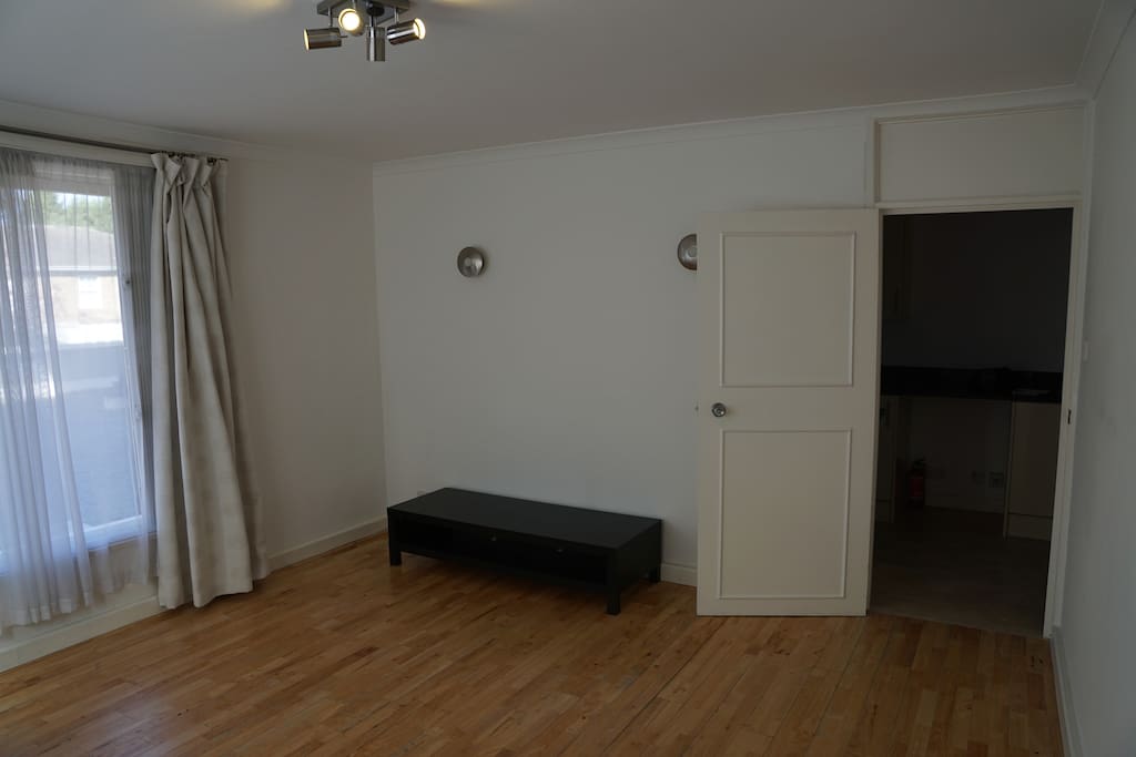 Bright front room with wooden flooring