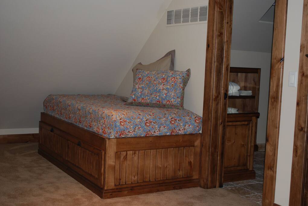 The bedroom has two of these twin beds, each with a full pull out storage drawer underneath