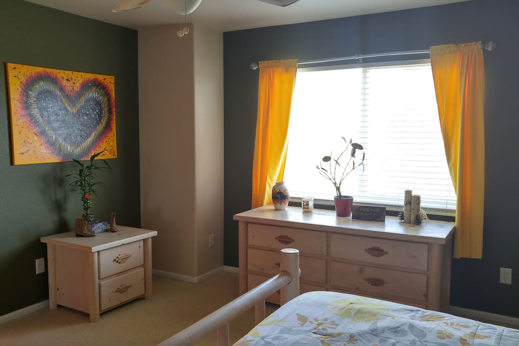 Bedroom has a lot of light & color.