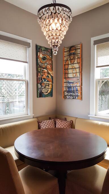 The warm and inviting banquette is roomy and features local folk art and a stunning chandelier.