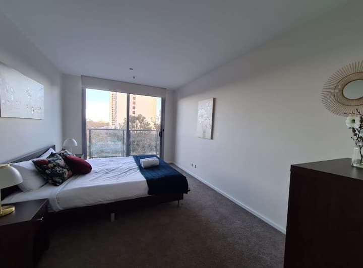 Comfy and tidy bedroom with built-in cabinet with a smooth to slide sliding mirrored doors where you can put your clothes and other belonging There is also a glass door that you can open to let the sunshine in and fresh air as well.