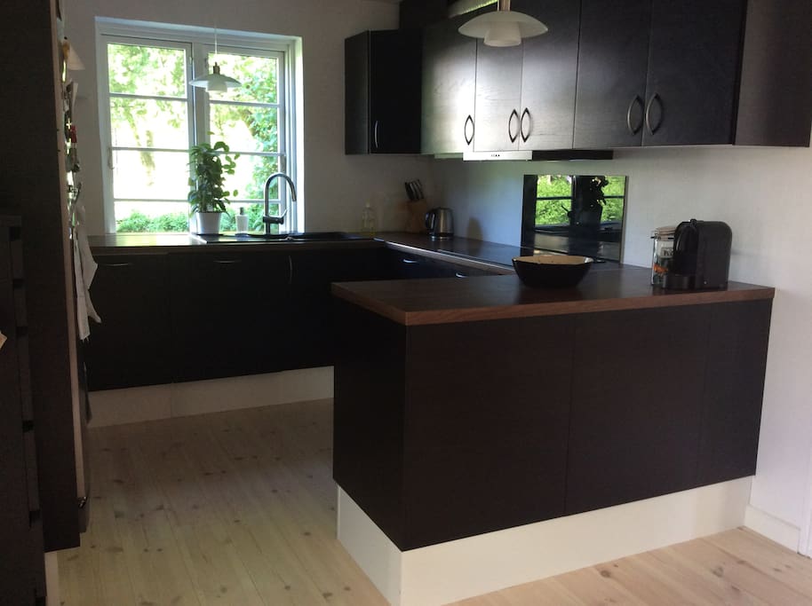 The kitchen which contains a dishwasher.