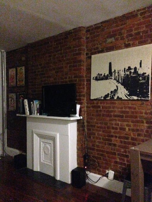 Exposed brick and TV with PS3 connected for Bluray, DVD, Netflix or Hulu