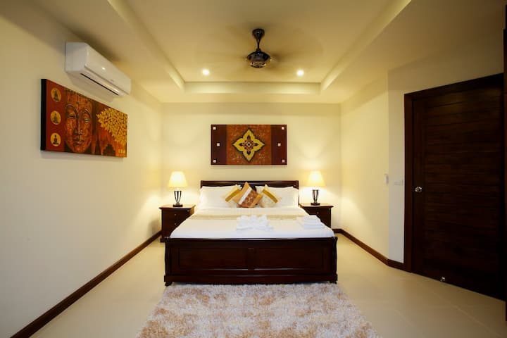Bedroom 4 upstairs with king size bed, air conditioning and ceiling fan