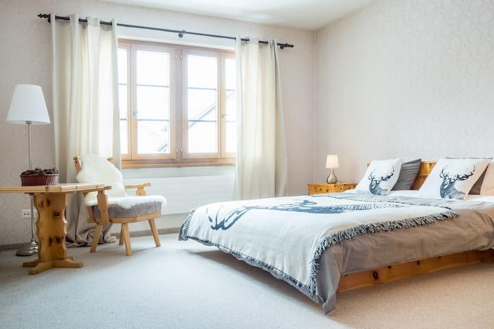 Room 1: Bright room with king size bed. TV