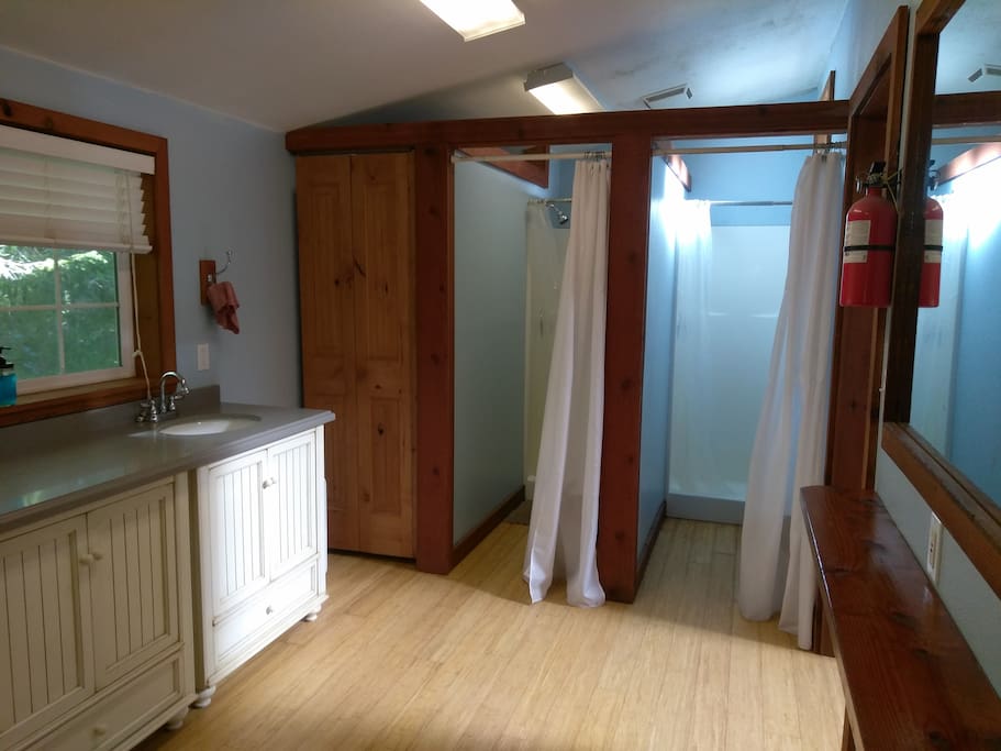Attached to the yurt is a communal bathroom space with 3 showers and 3 bathroom stalls.