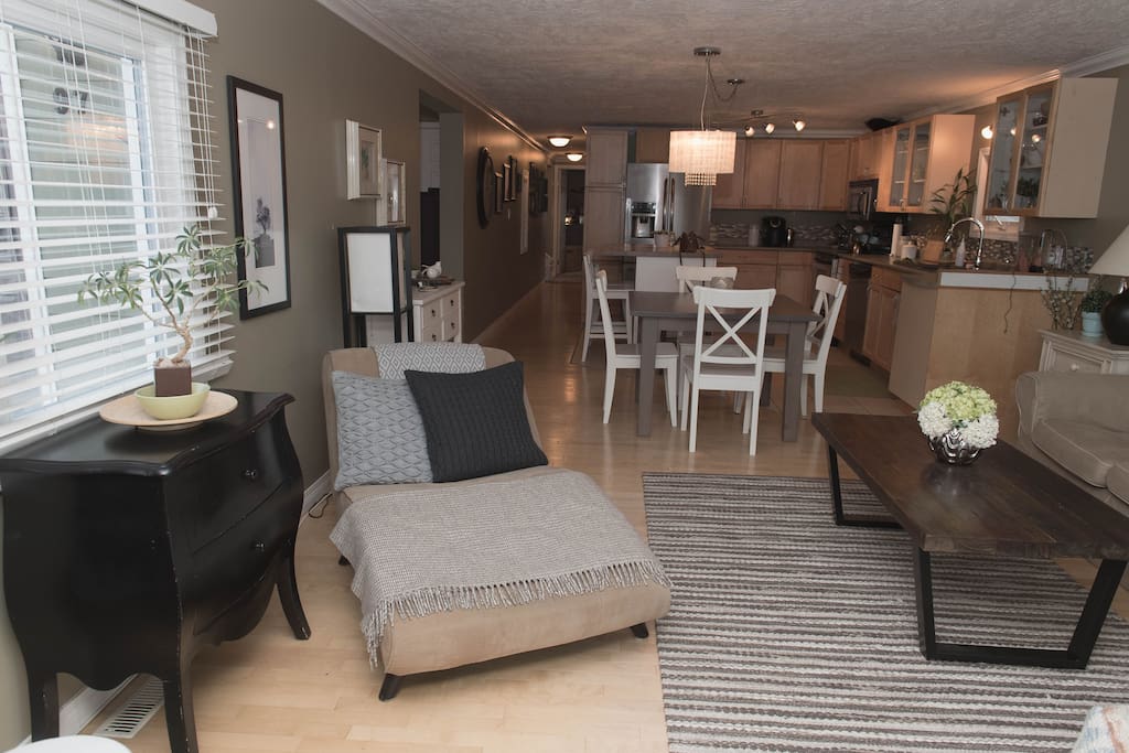 View off living room of Kitchen and hallway leading to rooms and bathrooms