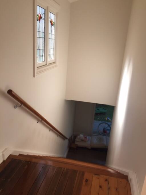 The stairs at the entryway lead down in the living space on the lower ground level.