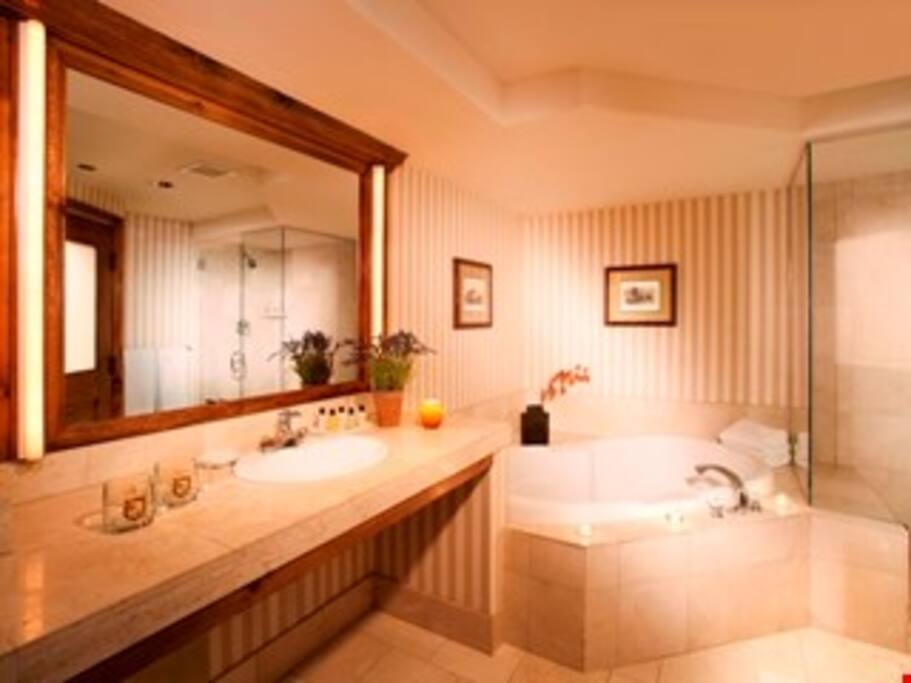 Prepare for the day in the luxurious marble bathroom.