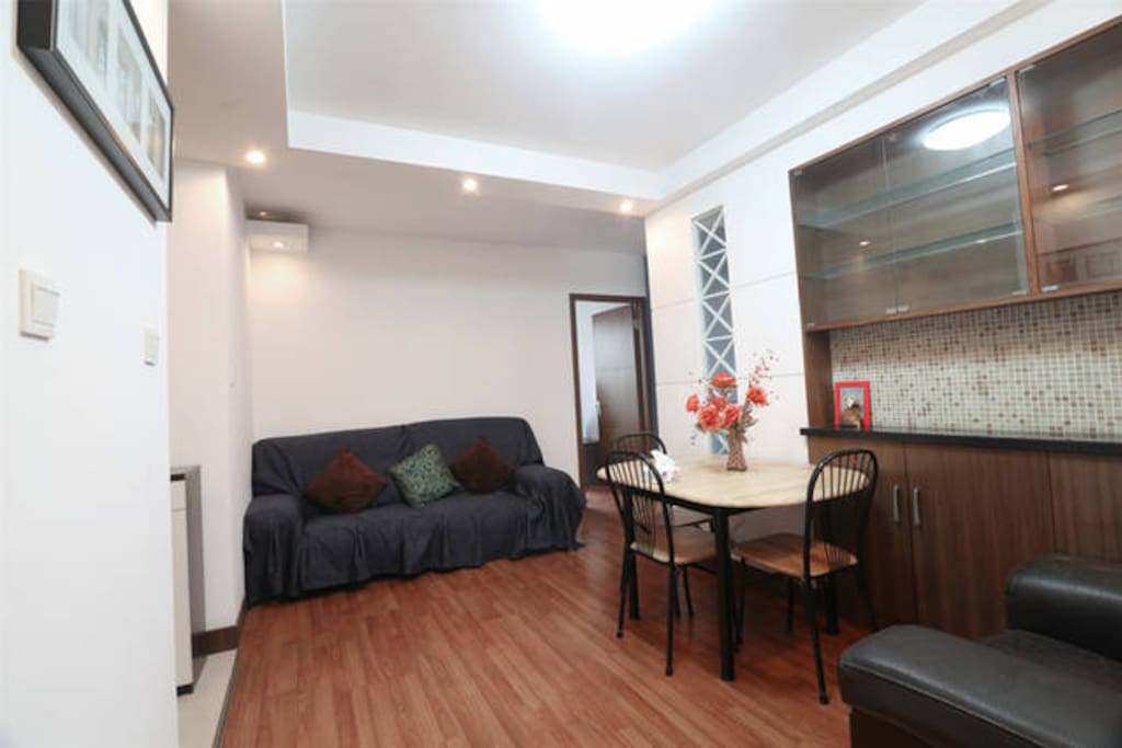Spacious living room with a big sofa and dinning table etc