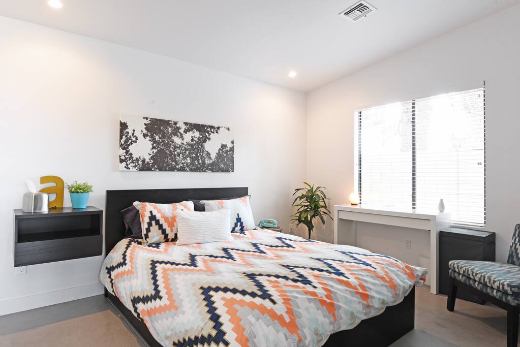 The comfortable bedroom has ample space to unpack and feel at home. The desk can be used as a vanity or a workspace.