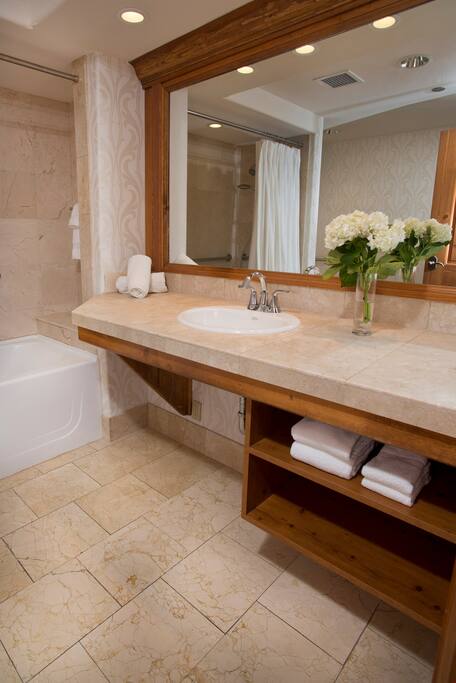 Prepare for the day in the luxurious marble bathroom.