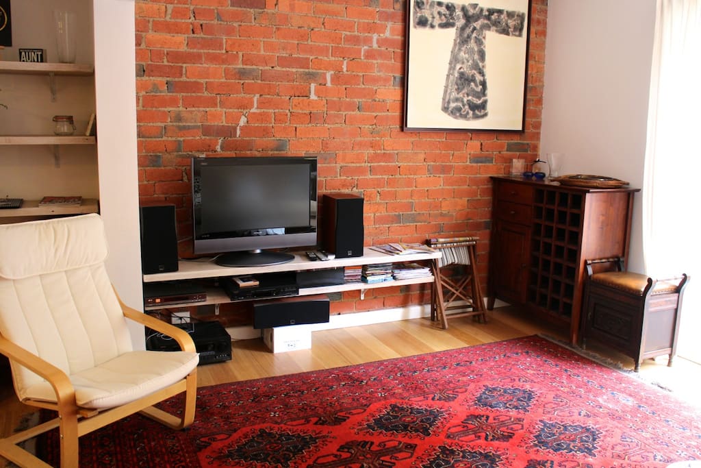 Relax in the large living area with couch and home entertainment system