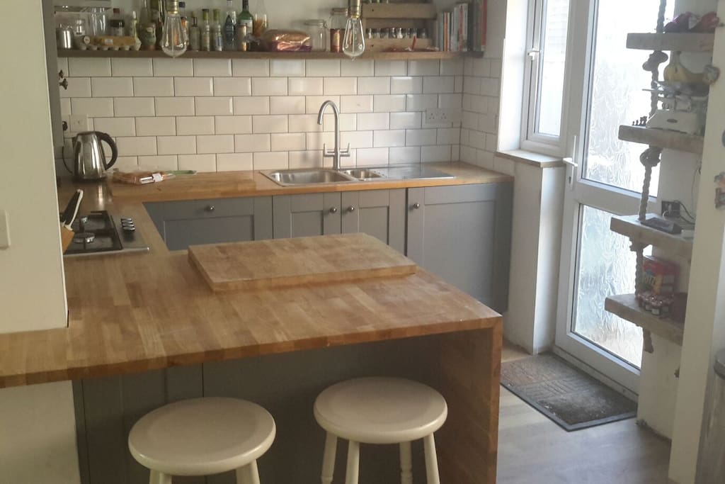 Newly furbished kitchen with oak worktop surface and breakfast bar.
