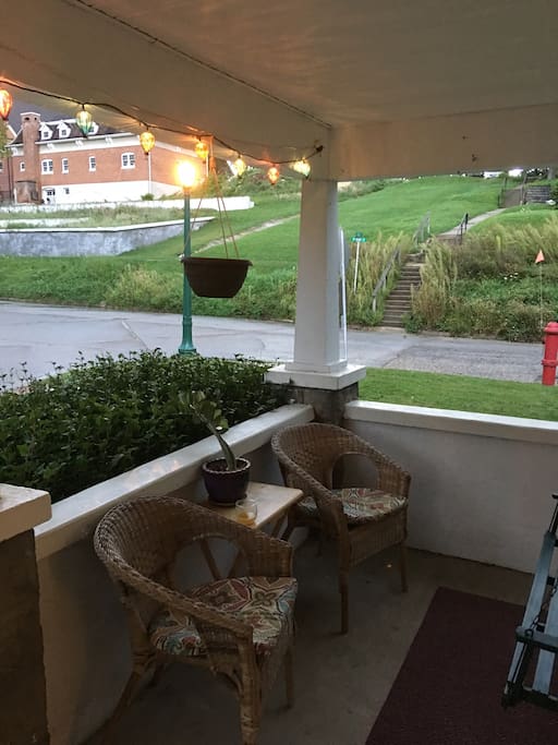 Porch sitting area. Two person swing just out of sight on the right.