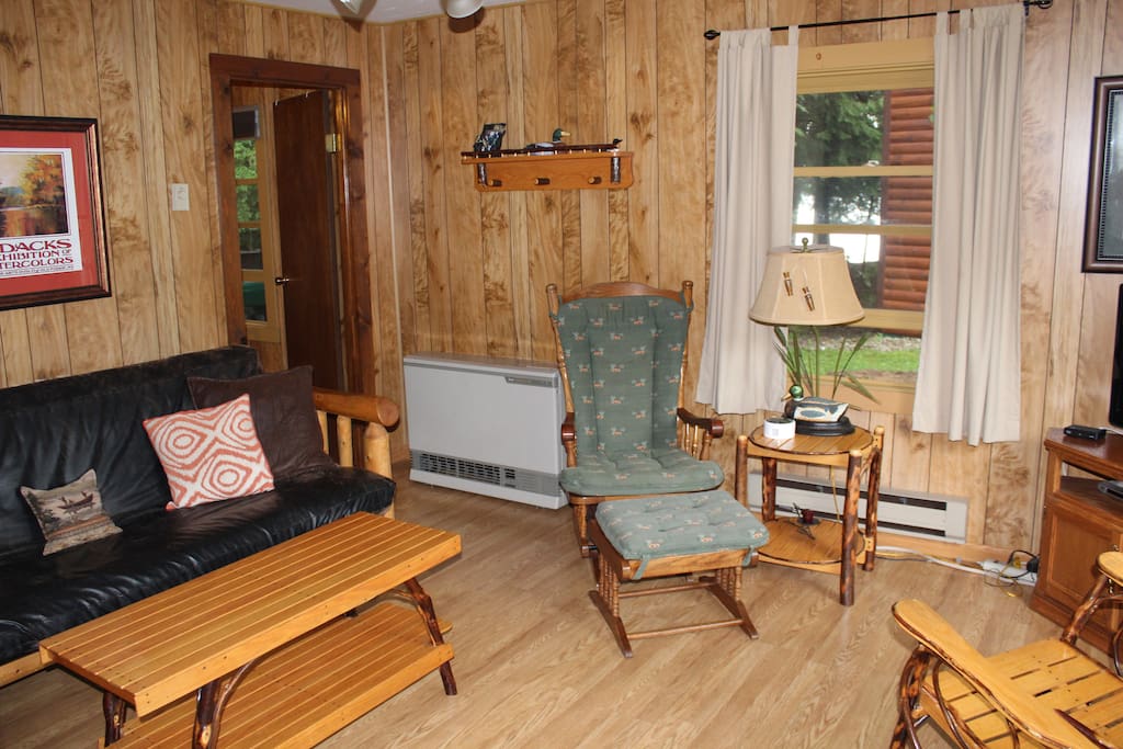 Living room with flat screen TV. Futon pulls out for extra sleeping room.
