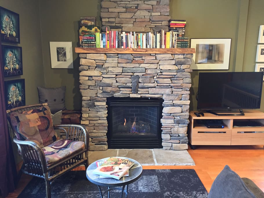 Fireplace in front of the sofa.