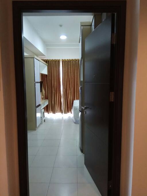 View from the main door to the main room which is equipped with air conditioner