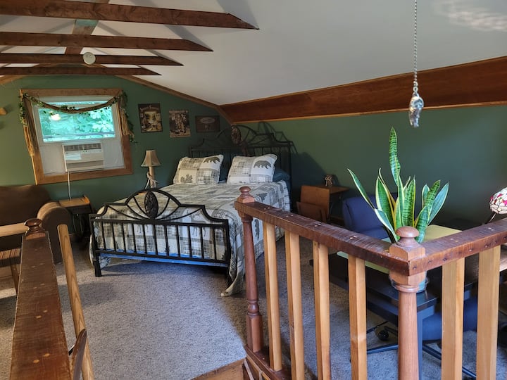 Queen size bed, work space and sitting area in the loft