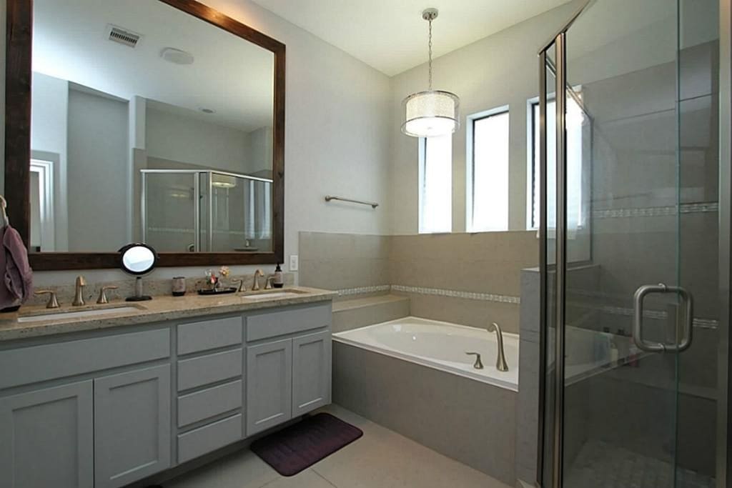 Chic bathroom with plenty of space. Oversized bathtub and large shower. Private toilet.