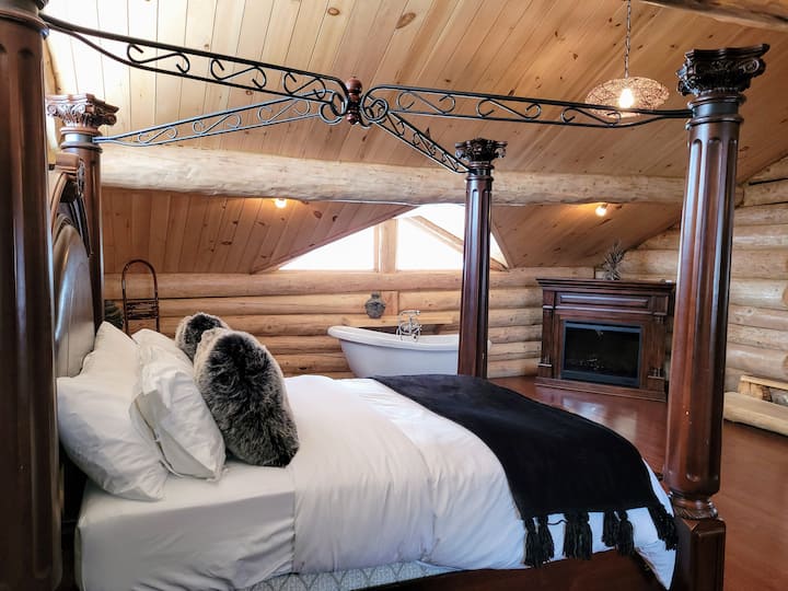 Master suite #1 with cathedral ceiling and clawfoot bath in bedroom. Adjacent bathroom. 