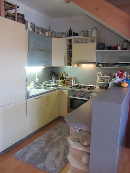 Kitchen, stairway in upper right hand corner of picture.