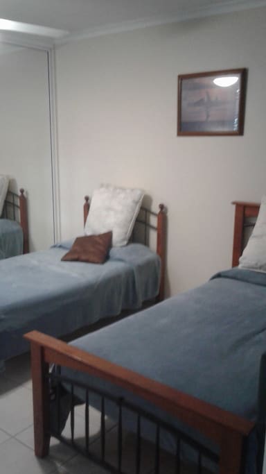 Two single beds in the second bedroom