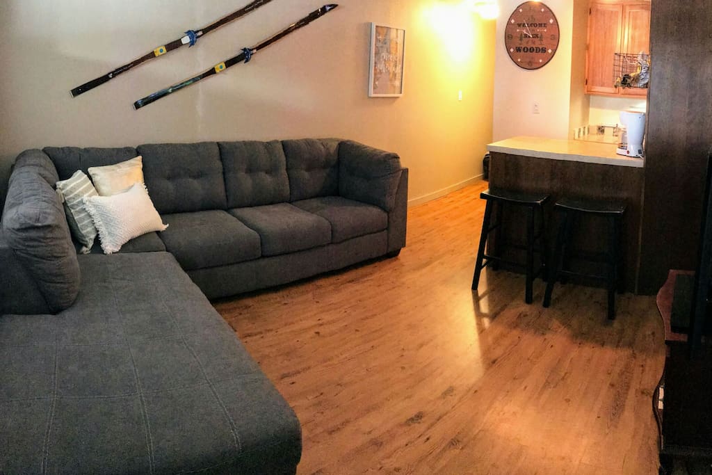 Living room with full-size sleeper sectional sofa + chaise