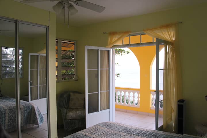 King bedroom with direct access to balcony overlooking ocean