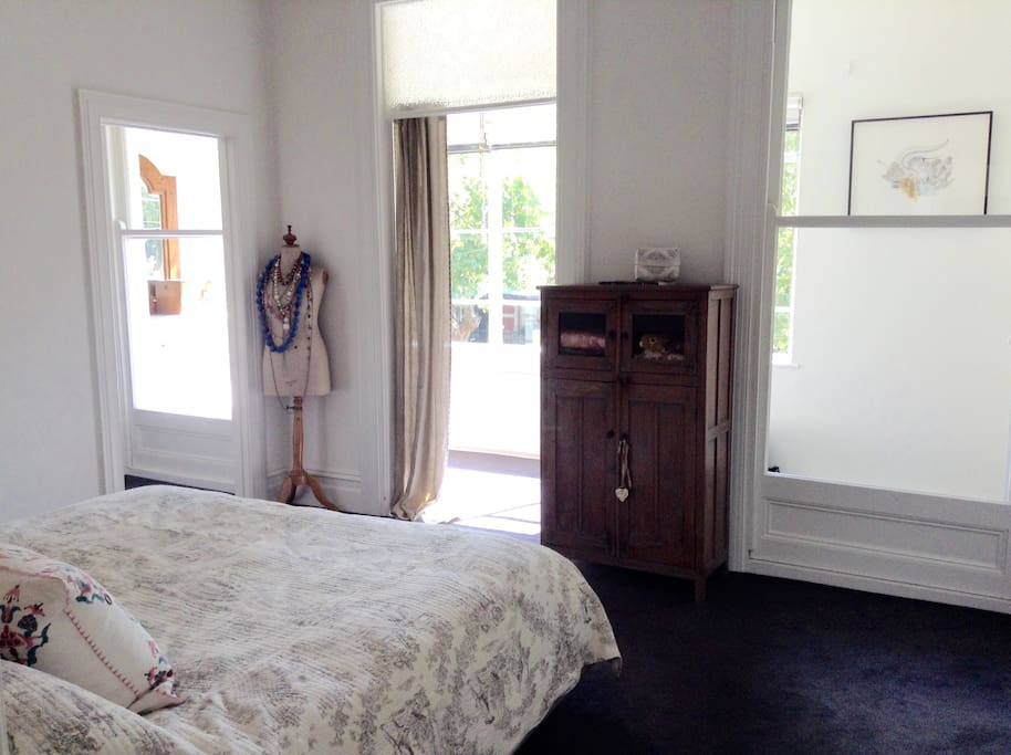 The master bedroom upstairs with an enchanting view of the city skyline. American king size bed (2m x 2m)