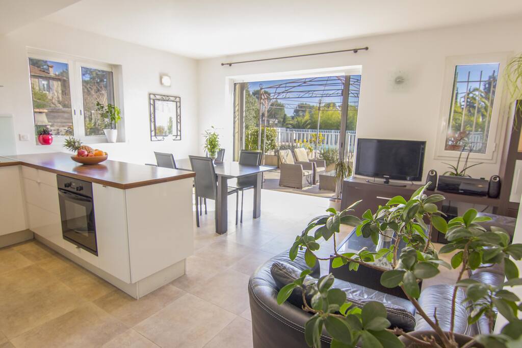 Large south-facing living room/kitchen, with TV and view over the pool
