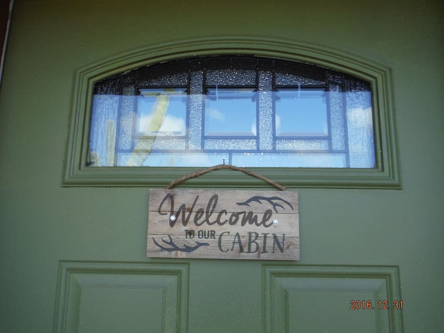 Look for the Welcome to our Cabin sign