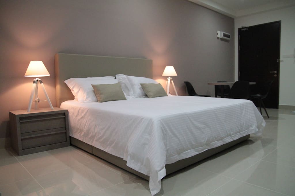 King-sized bed with fluffy pillows.