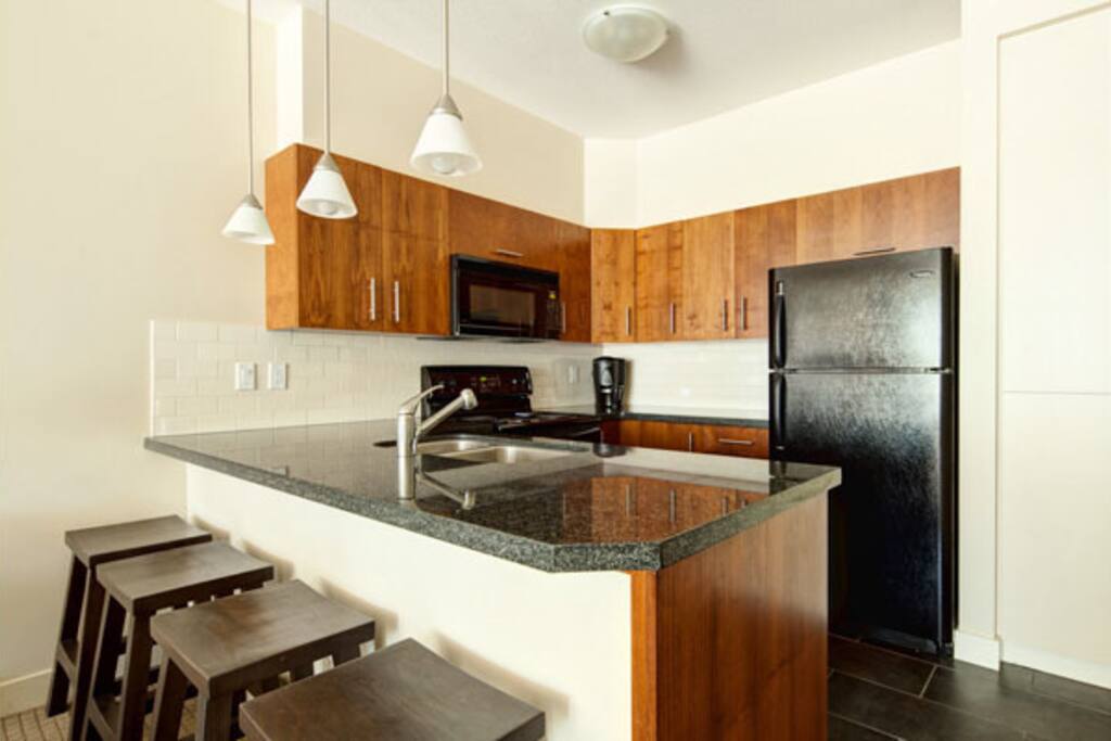 The kitchen features lots of counter-space and a breakfast bar
