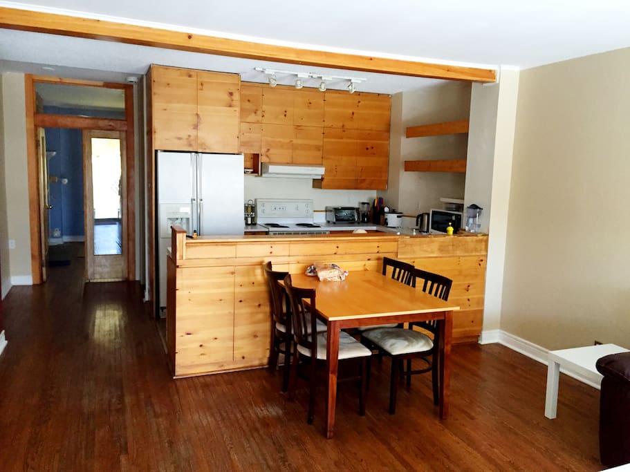 A view of the kitchen and dining table, from the back door.