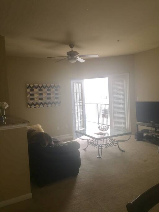 Living room with couch and access to balcony