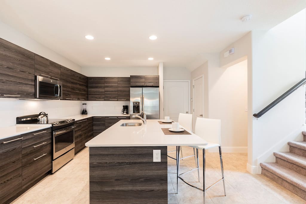 The kitchen comes complete with sink, oven, stove, microwave, dishwasher and fridge.