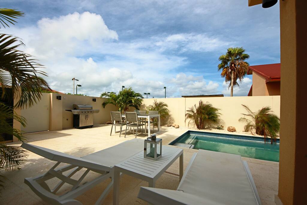 Your private swimming pool with dining table, BBQ-grill, and lounge chairs