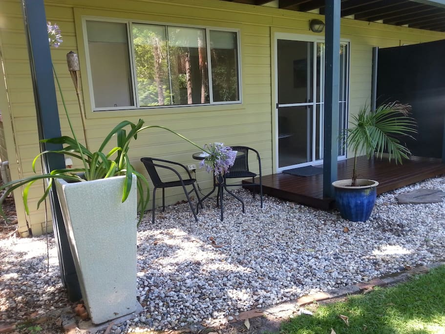 Private deck area overlooking a lush garden.
